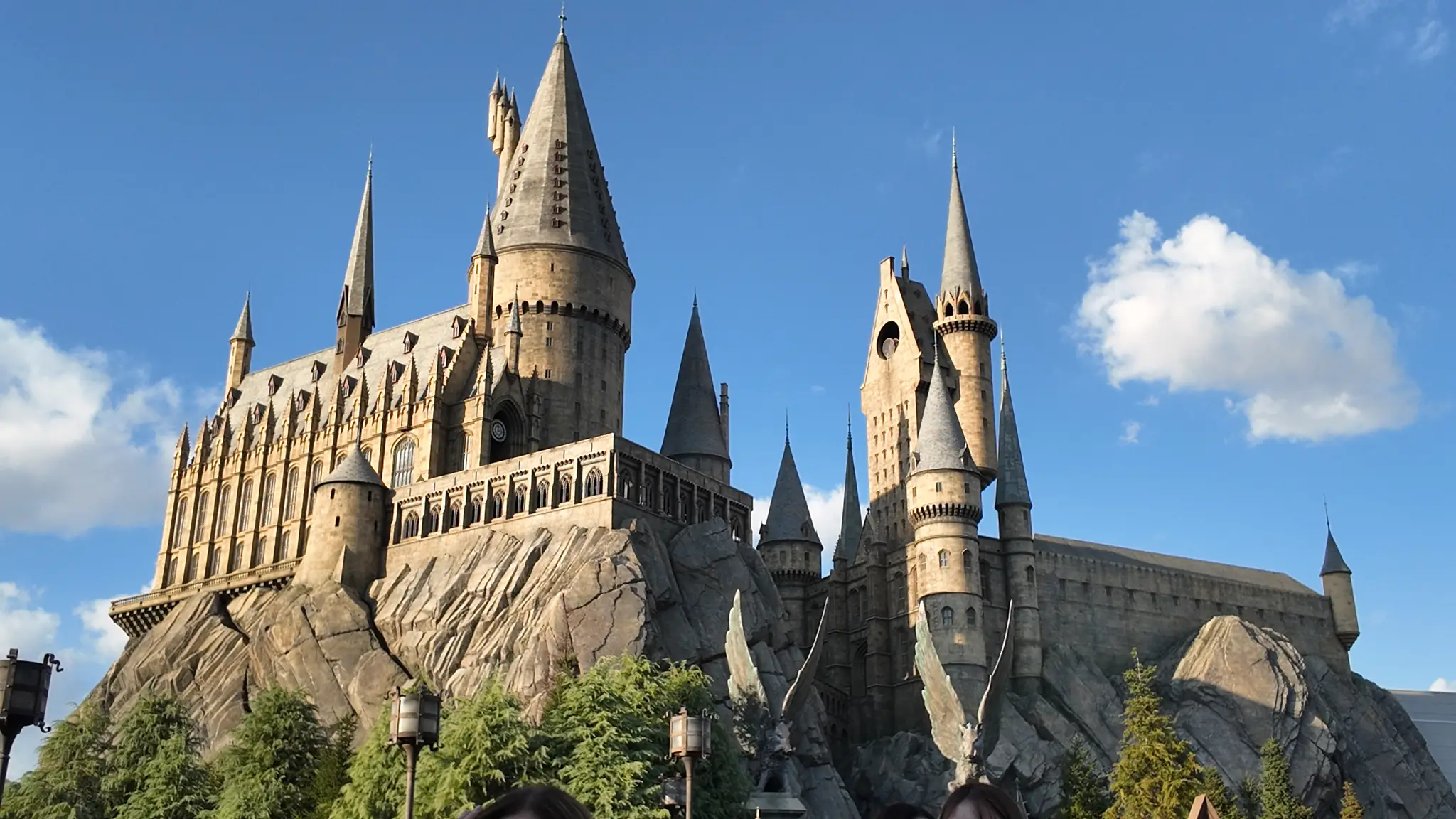 Hogwarts Castle under a blue sky with white clouds