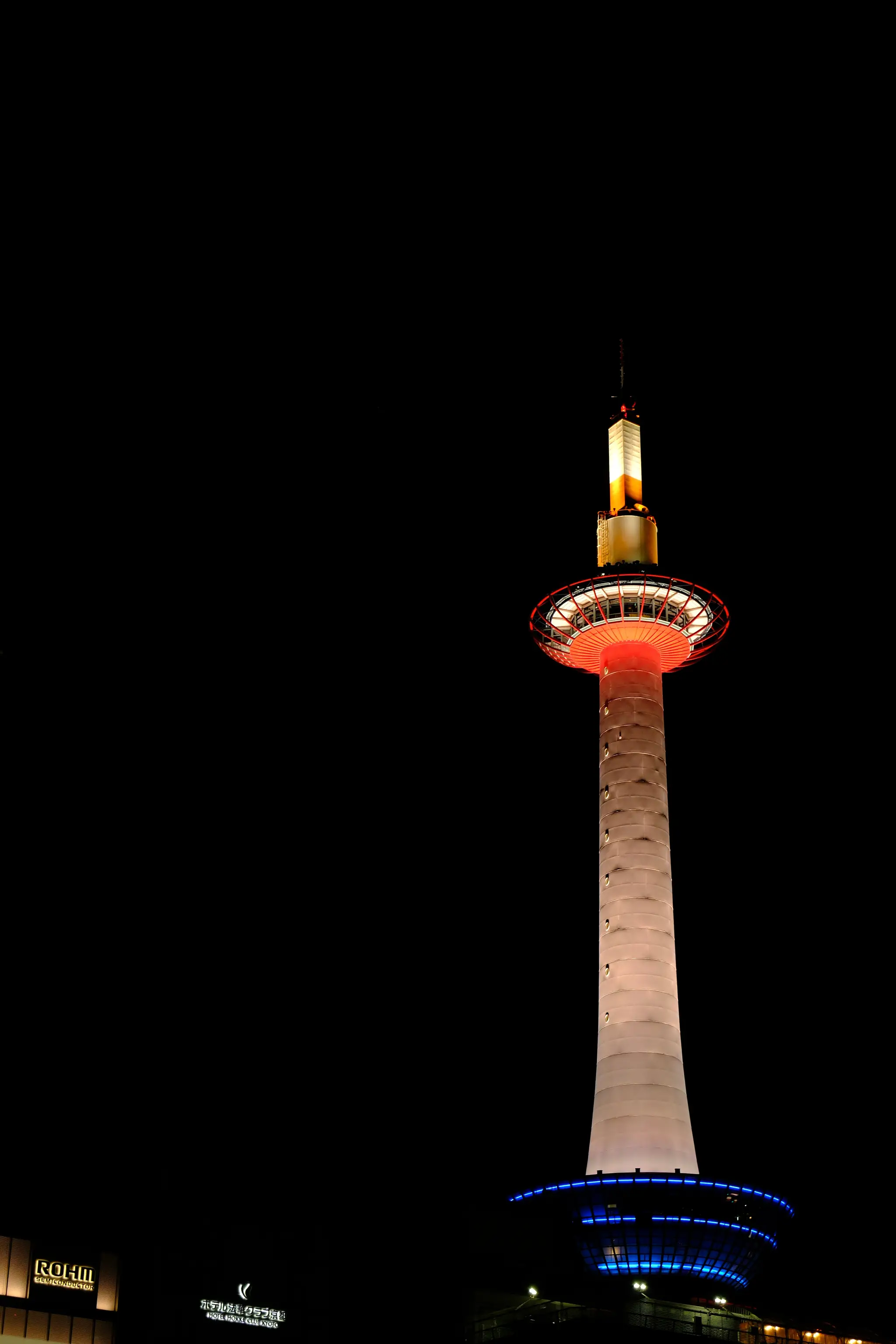 Kyoto Tower lit up against the night sky