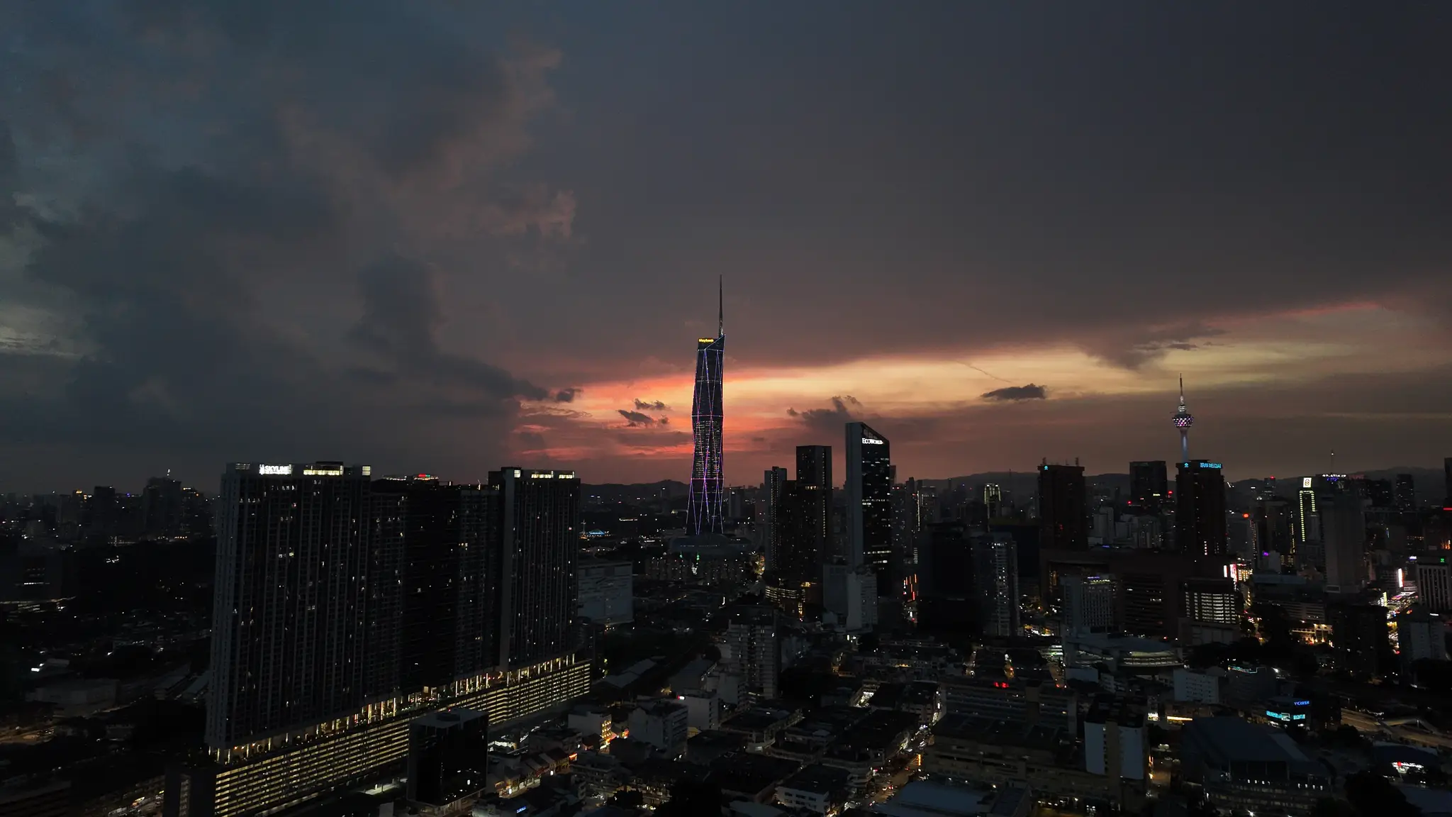 The Kuala Lumpur skyline under a dramatic sunset sky